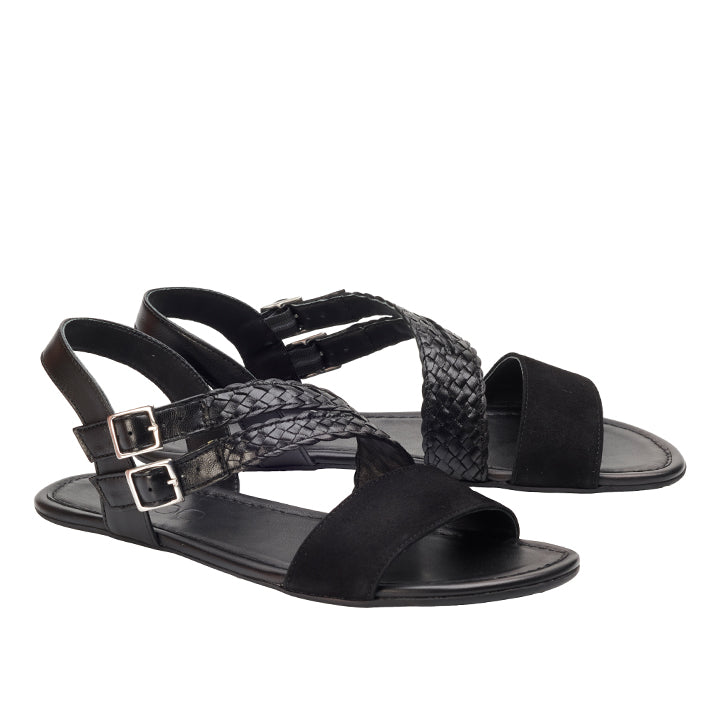 Die ZAQQ BROOQE Black Sandalen sind aus luxuriösem Nappa- und Veloursleder gefertigt und verfügen über ein geflochtenes Riemendesign mit zwei verstellbaren Schnallen. Diese femininen Sandalen haben ein offenes, flaches Design, das sich ideal für den Freizeitlook eignet.