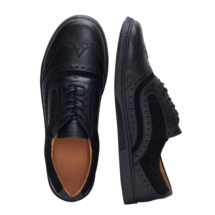 Die BRIQ Brogue Deep Black Schuhe von ZAQQ, gefertigt aus geschmeidigem Kalbsleder, werden von der Seite und von oben gezeigt. Diese eleganten Schuhe zeigen komplizierte Lochmuster und strahlen mit hellbrauner Innenseite ein elegantes, poliertes Erscheinungsbild aus.