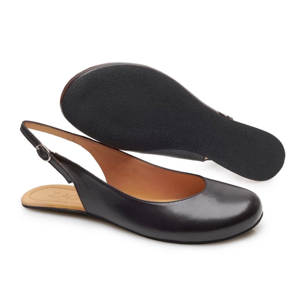 Ausgestellt sind die PINQ Slingback-Schuhe aus schwarzem Leder von ZAQQ, ideal für alle, die die Eleganz von Ballerinas zu schätzen wissen. Ein Schuh steht aufrecht und zeigt seine abgerundete Spitze und sein schlankes Design, während der andere umgedreht ist, um seine strukturierte Sohle und sein Engagement für Komfort bei jedem Schritt hervorzuheben.